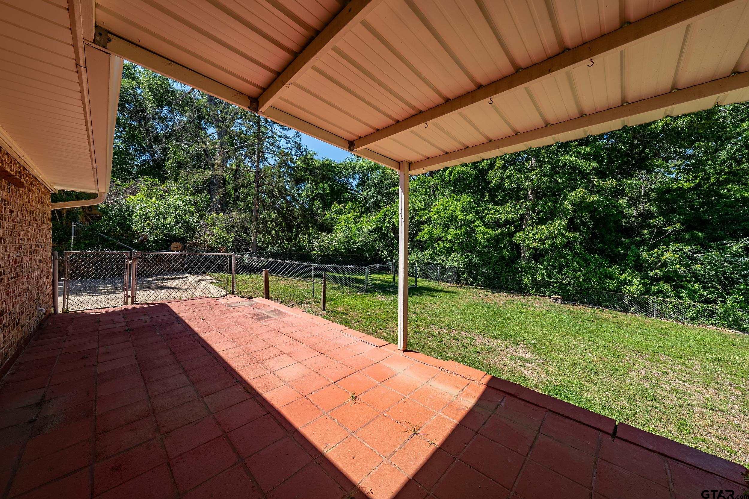 2026 Neeley Street Tyler, TX 75701 - Photo 23 of 26 a view of a backyard with wooden floor