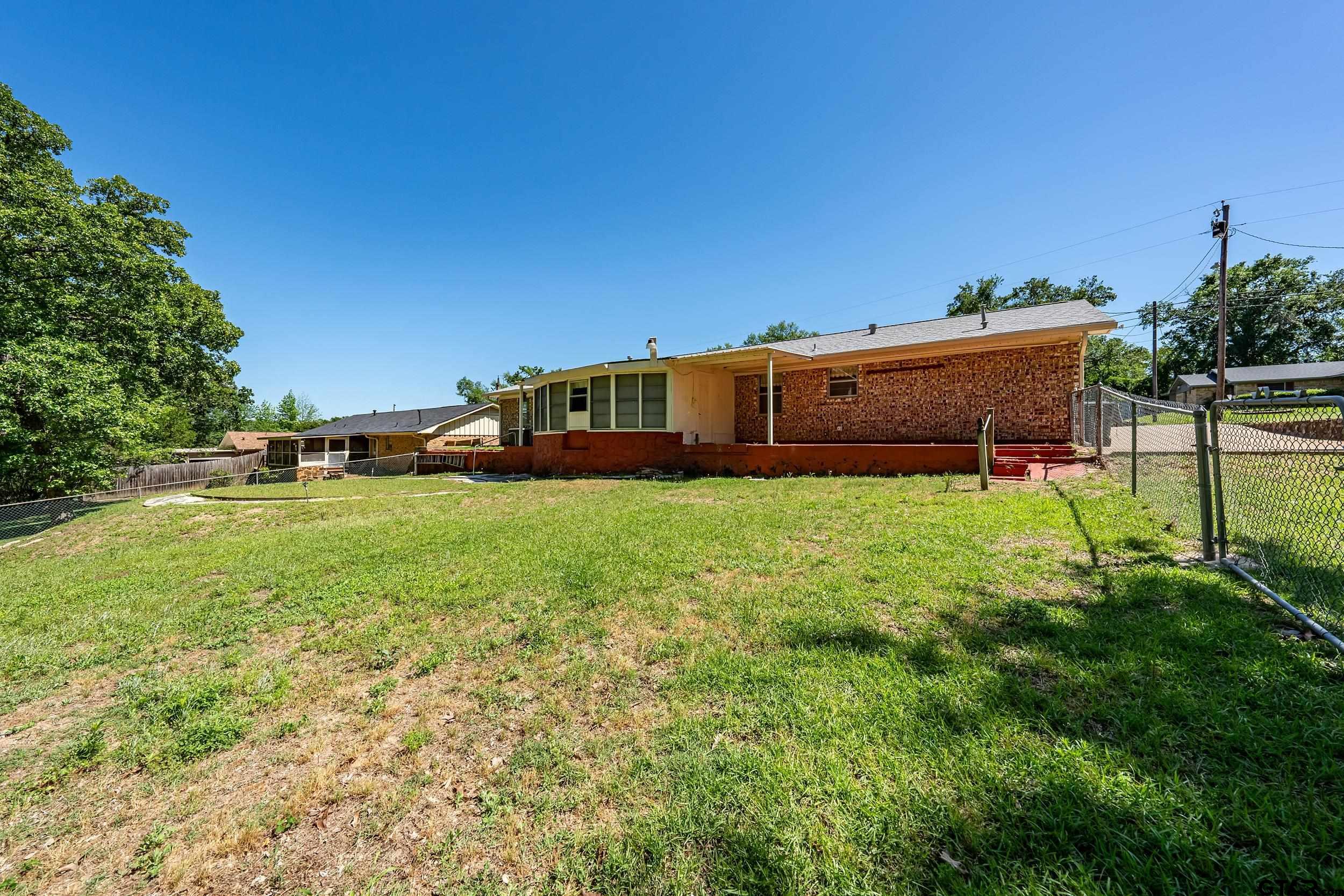 2026 Neeley Street Tyler, TX 75701 - Photo 24 of 26 a view of yard with green space and bench in the background