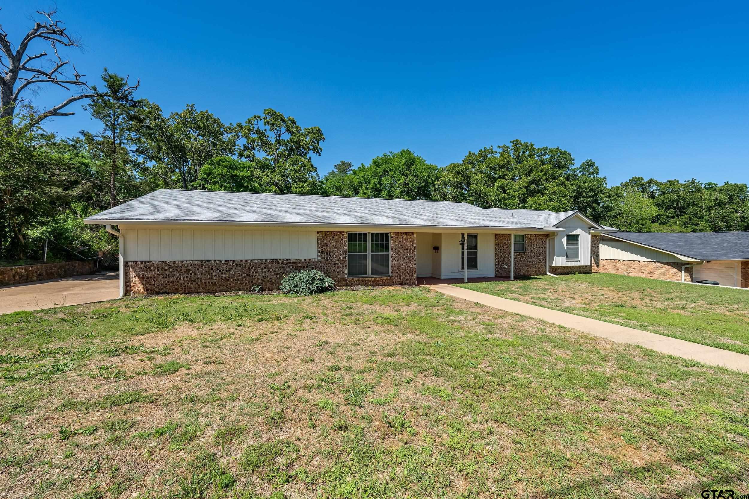 2026 Neeley Street Tyler, TX 75701 - Photo 3 of 26 a front view of a house with a yard and garage