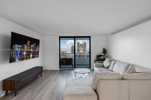 a living room with furniture and a floor to ceiling window