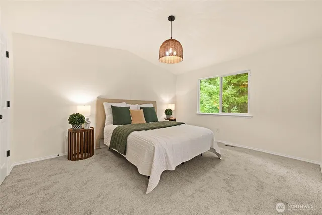 a bedroom with a bed and a chandelier