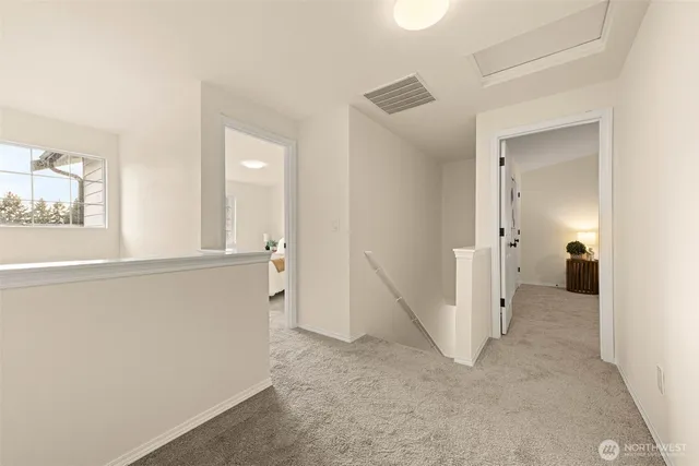 a large bed sitting in a bedroom next to a window and a chandelier