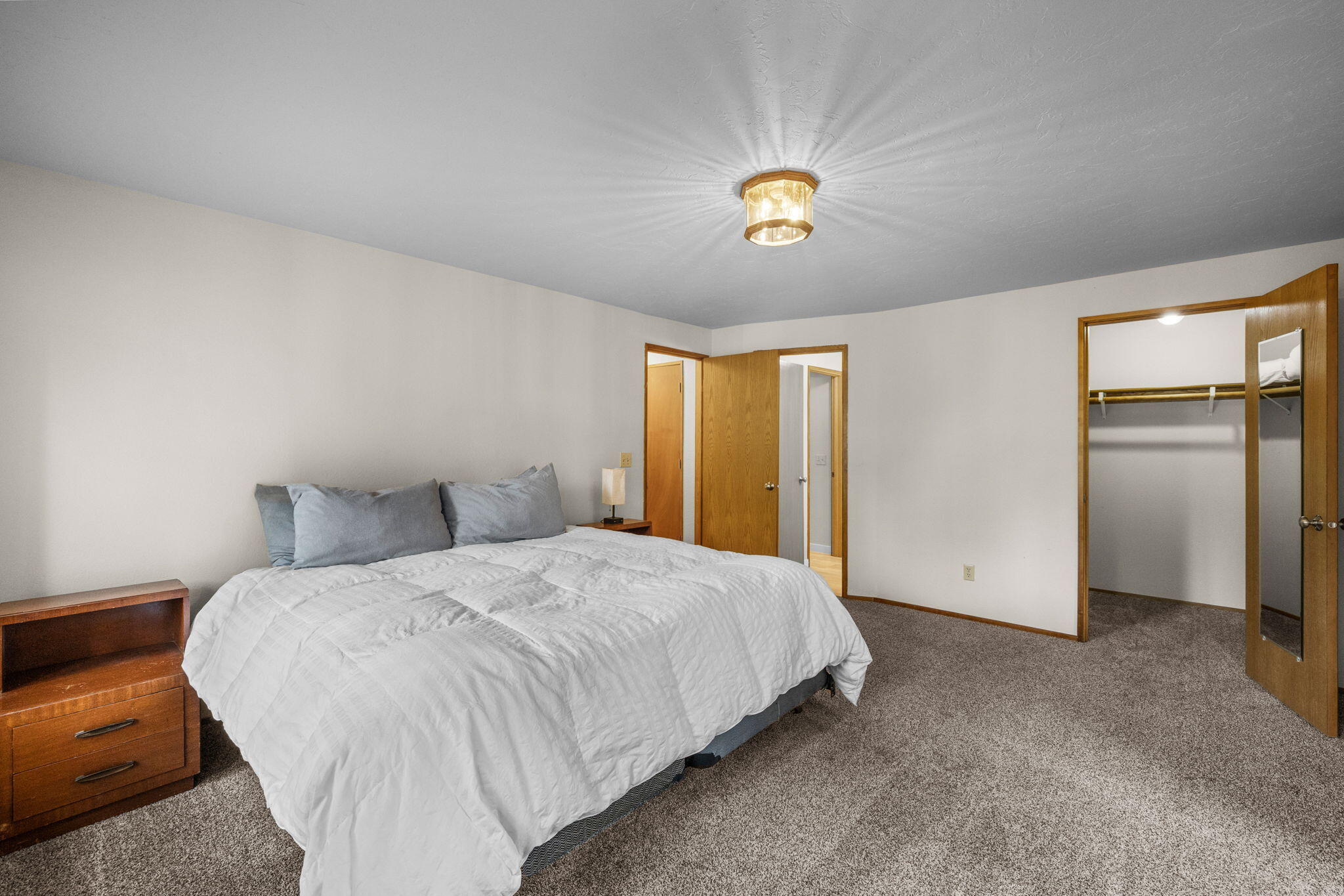 13168 Hawks Beard Black Butte Ranch, OR 97759 - Photo 13 of 47 a bedroom with a bed and a chandelier