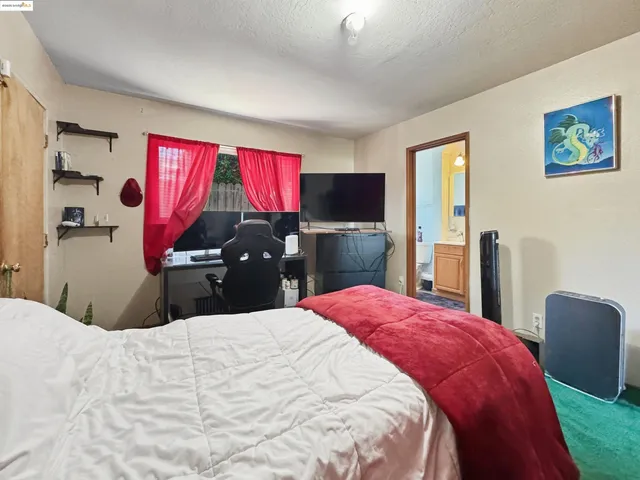 a bedroom with a bed and a flat screen tv