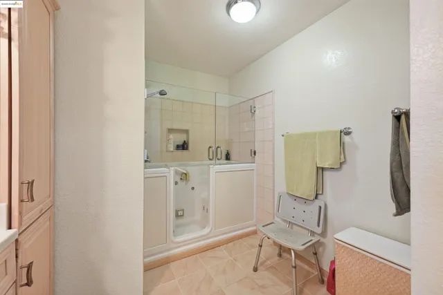 a spacious bathroom with a double vanity sink and a mirror