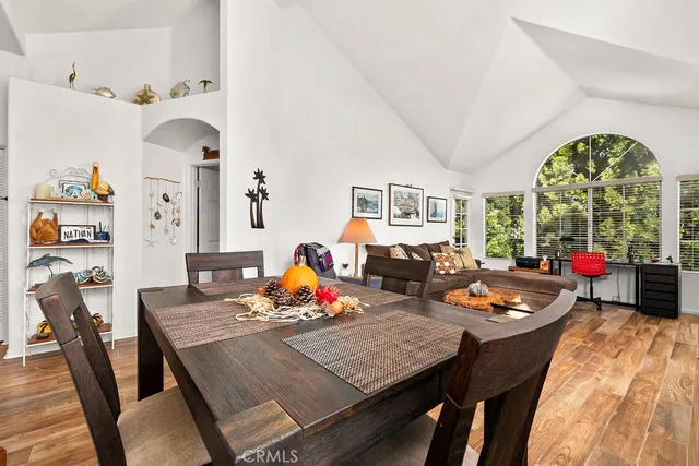 a living room with furniture a window and a flat screen tv