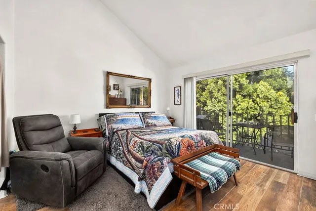 a bedroom with a bed and a lamp on dresser