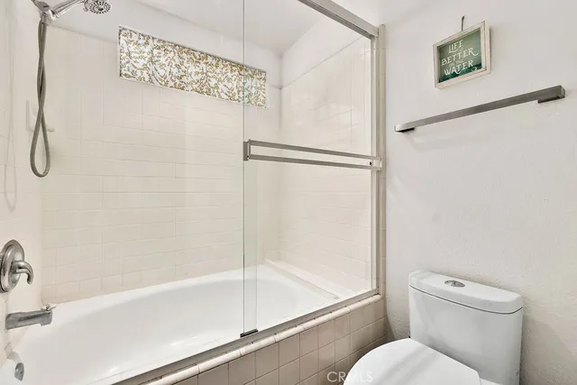 a bedroom with a bed and flat screen tv