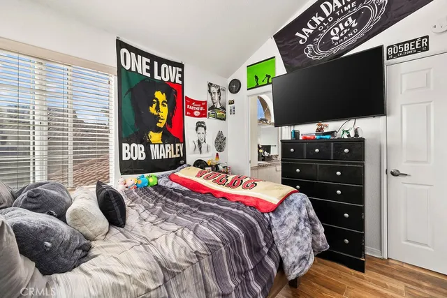 a bed room with a bed and painting on the wall