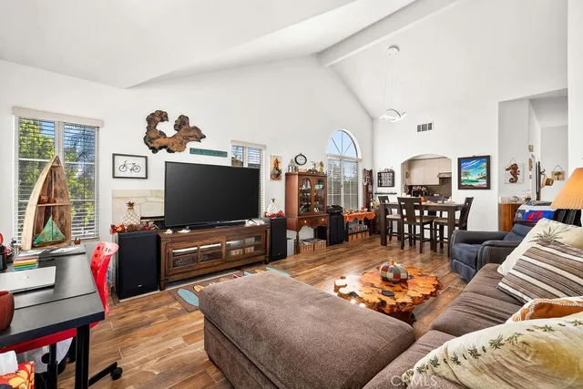 a living room with furniture and wooden floor
