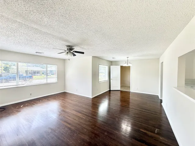 a view of a hallway with wooden floor and closet