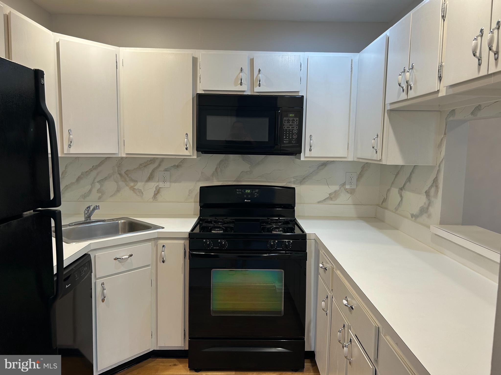 35 Coral Tree Court Lawrence Township, NJ 08648 - Photo 6 of 13 a kitchen with granite countertop white cabinets and stainless steel appliances