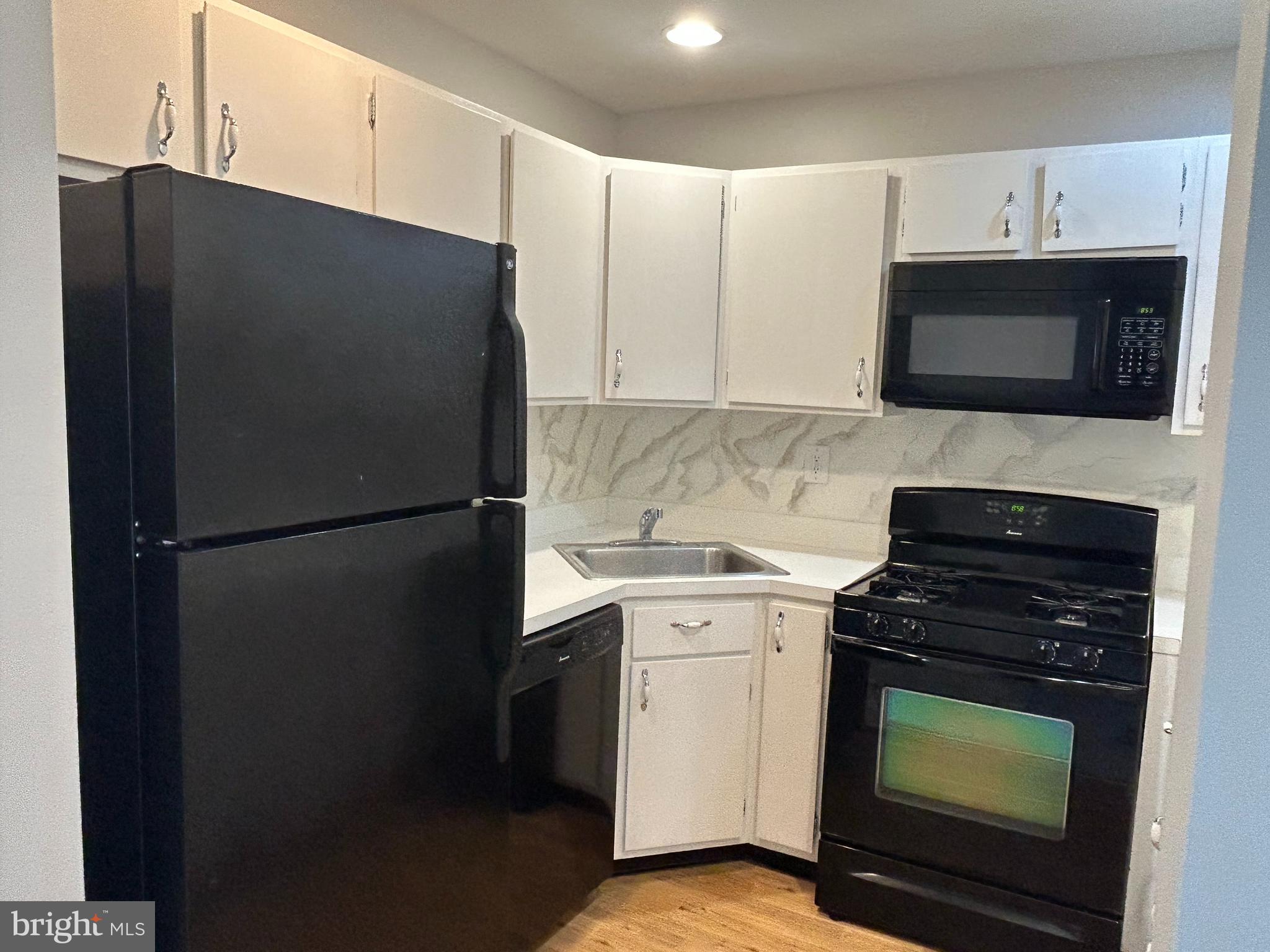 35 Coral Tree Court Lawrence Township, NJ 08648 - Photo 8 of 13 a kitchen with a stove and a refrigerator