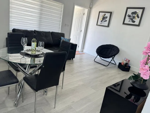 a view of a dining room with furniture and a window