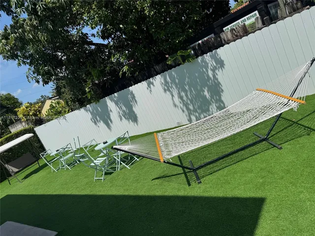 a view of a backyard with sitting area