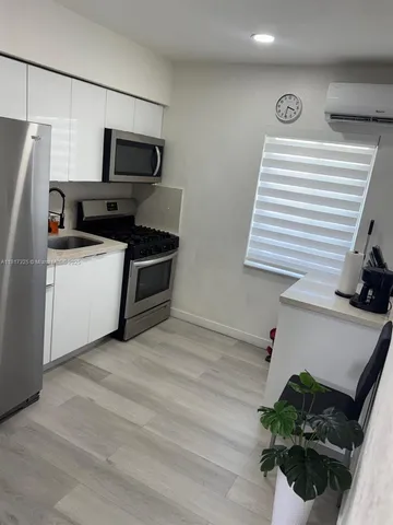 a kitchen with a refrigerator and a sink