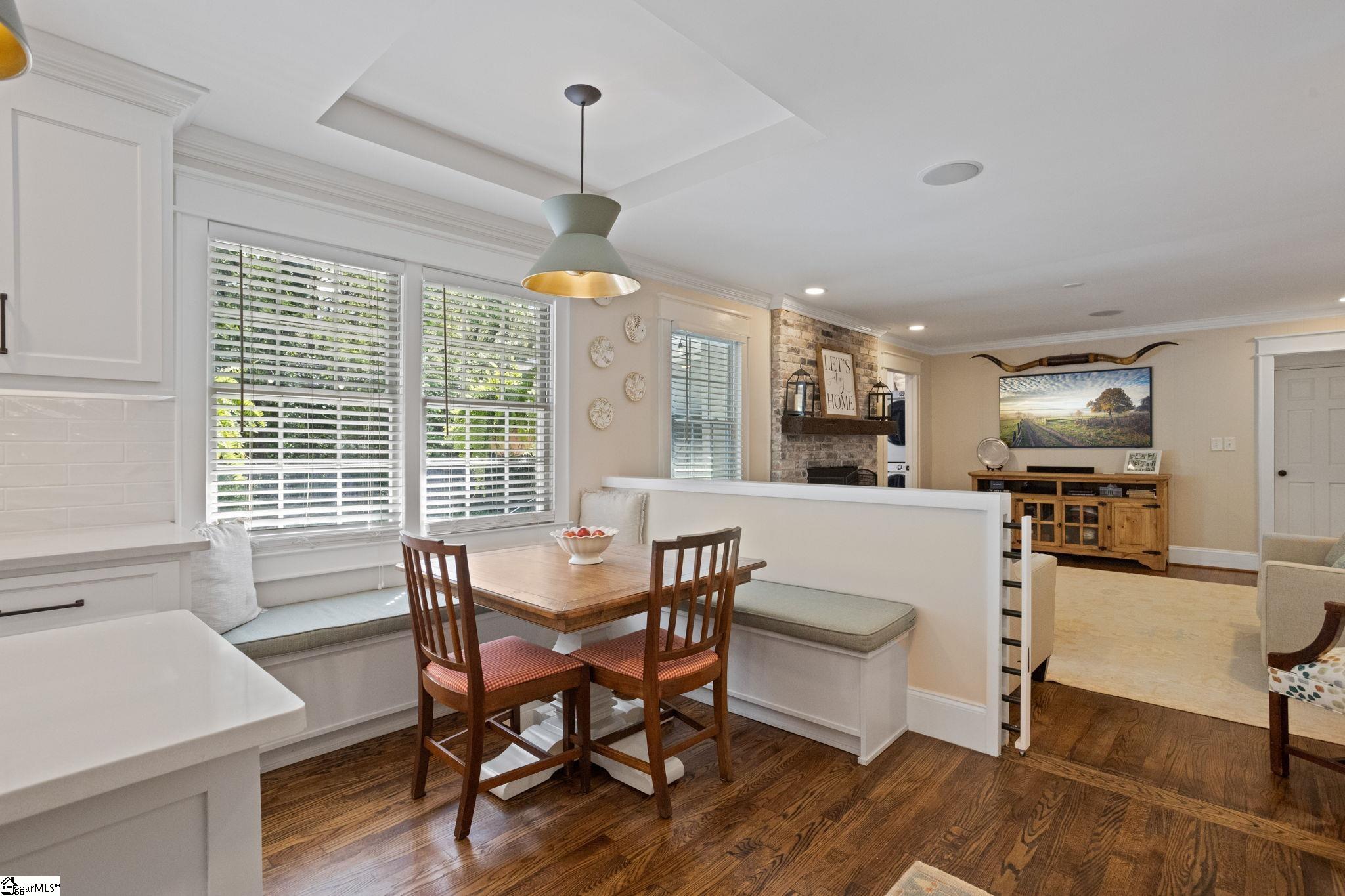 117 Windfield Road Greenville, SC 29607 - Photo 9 of 36 Seller Added Tray Ceiling and Banquette w/ Storage, Took Wall Down Between Kitchen and Second Living Room to Create Half Wall Open Concept Flow
