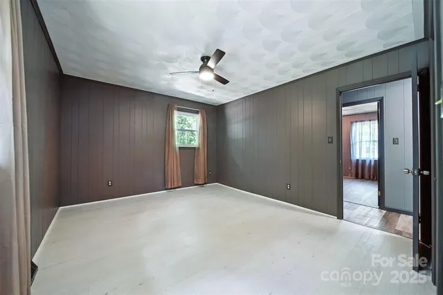 a view of a livingroom with a ceiling fan and window