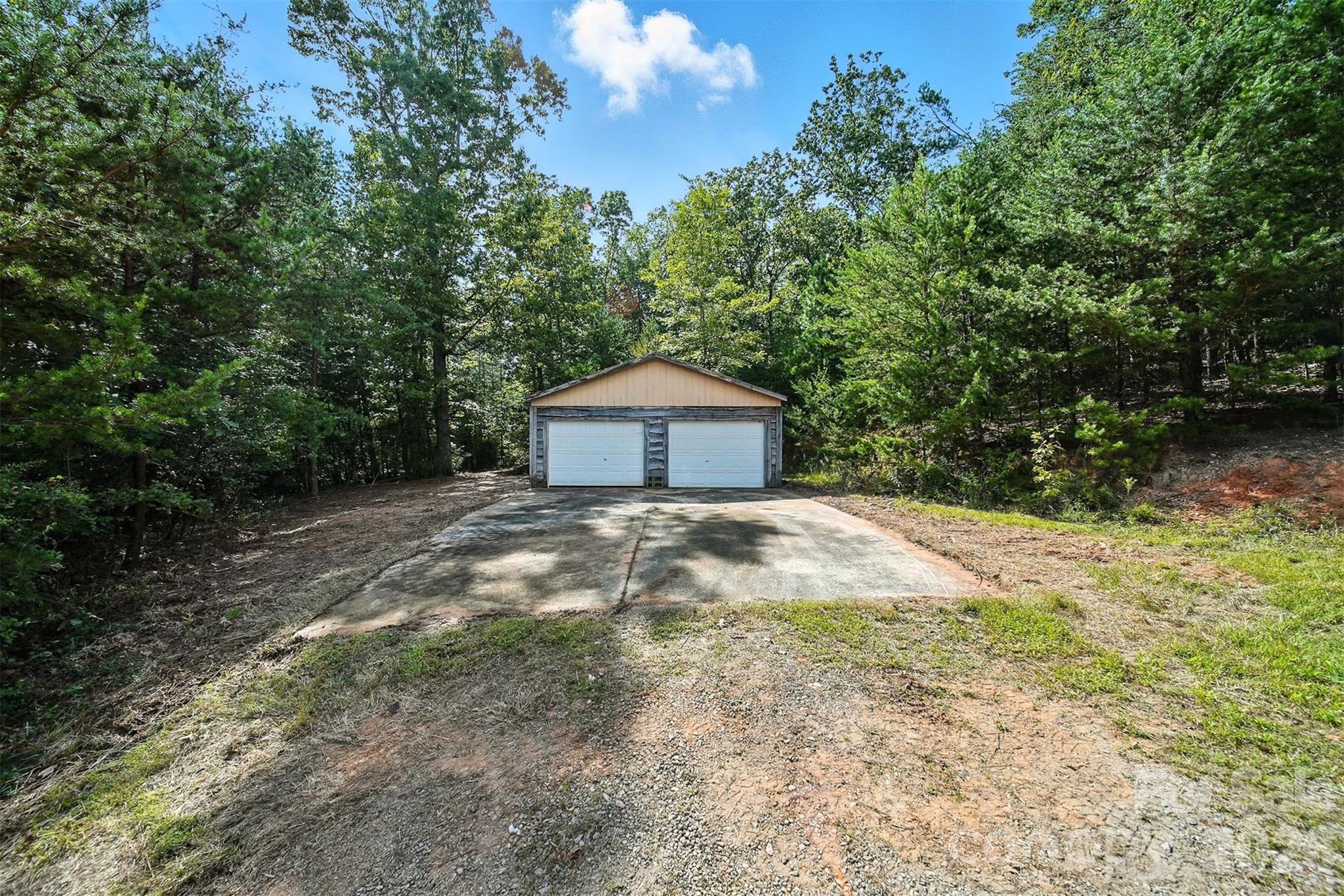 4967 Sugar Loaf Road Morganton, NC 28655 - Photo 7 of 37 a backyard of a house with large trees and a forest