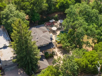an aerial view of a house with a yard