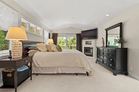 a spacious bathroom with a large tub shower and windows