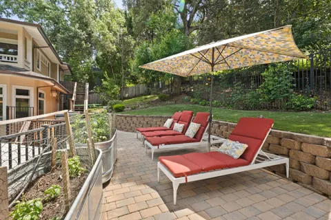 a view of a house with swimming pool and sitting area