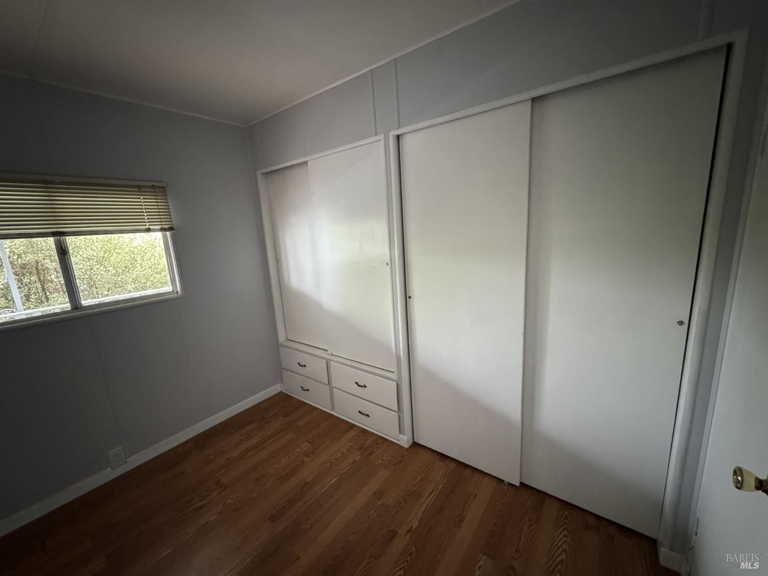 150 Silverado Trail, Unit 29 Napa, CA 94559 - Photo 16 of 18 an empty room with wooden floor cabinet and windows