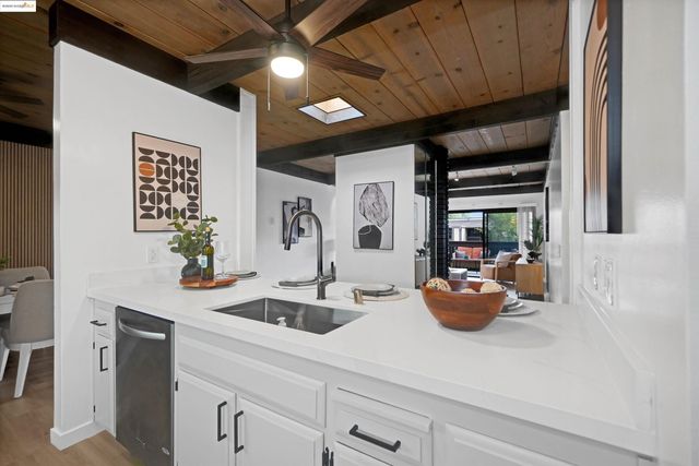 a kitchen with a sink appliances and cabinets