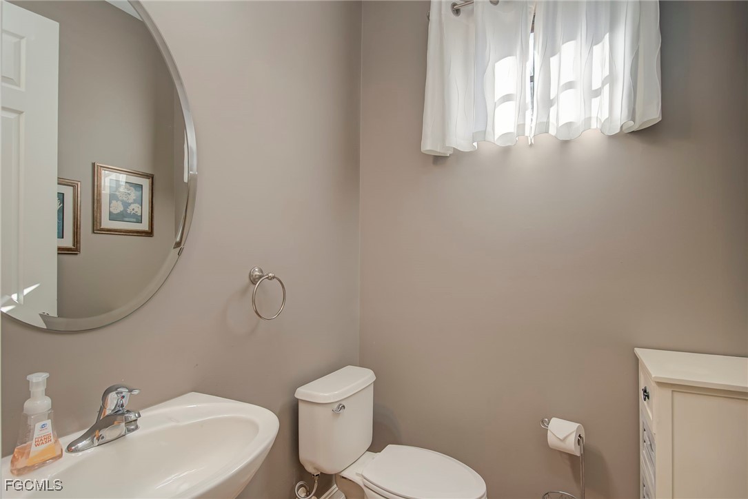 11856 Rocio Street, Unit 2003 Fort Myers, FL 33912 - Photo 12 of 43 a bathroom with a toilet a sink and mirror