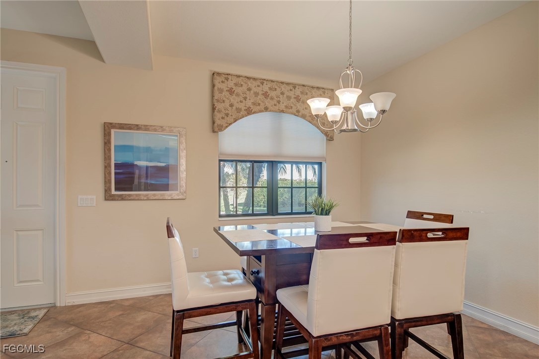 11856 Rocio Street, Unit 2003 Fort Myers, FL 33912 - Photo 13 of 43 a view of a dining room with furniture and chandelier