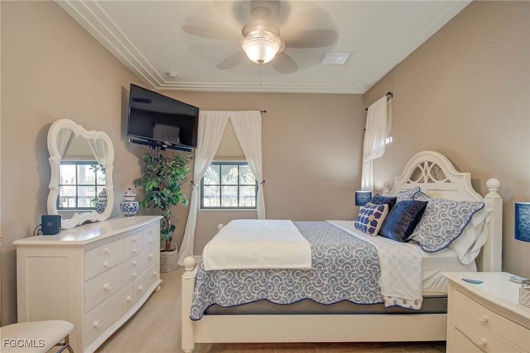 11856 Rocio Street, Unit 2003 Fort Myers, FL 33912 - Photo 17 of 43 a bedroom with a large bed and a chandelier
