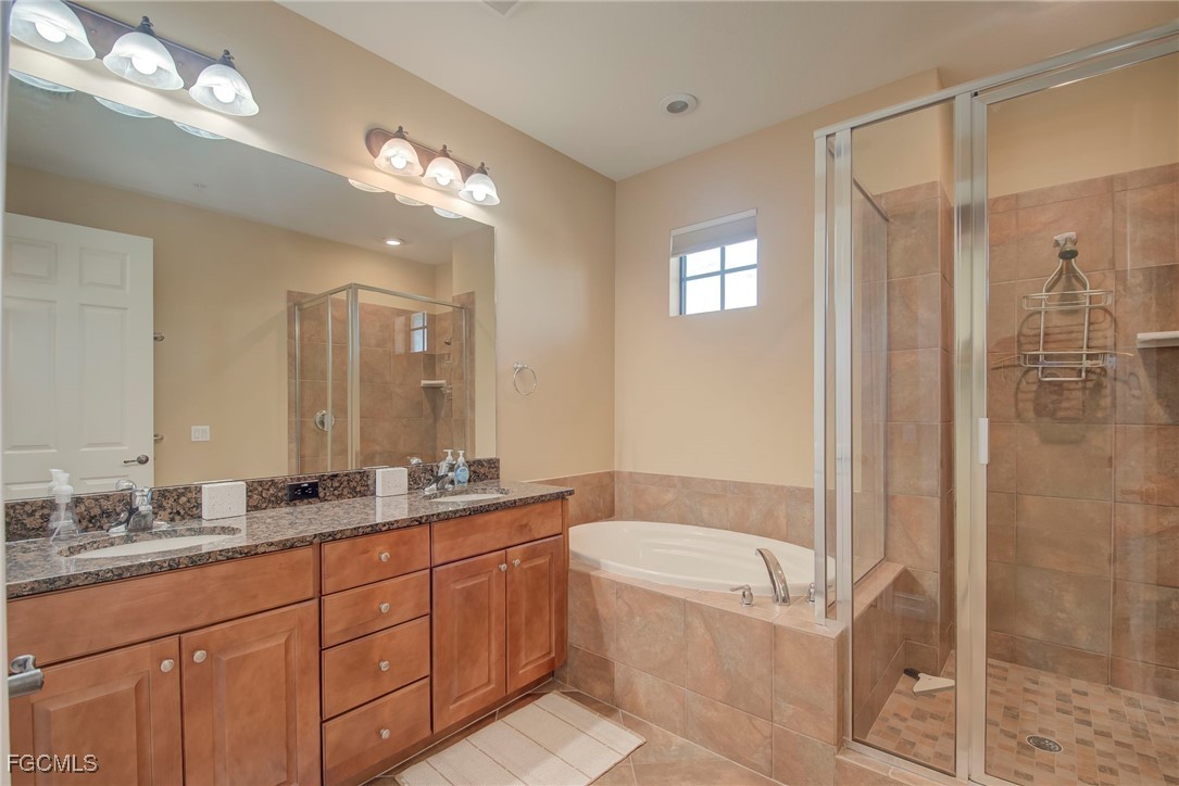 11856 Rocio Street, Unit 2003 Fort Myers, FL 33912 - Photo 19 of 43 a bathroom with a granite countertop tub sink shower and mirror