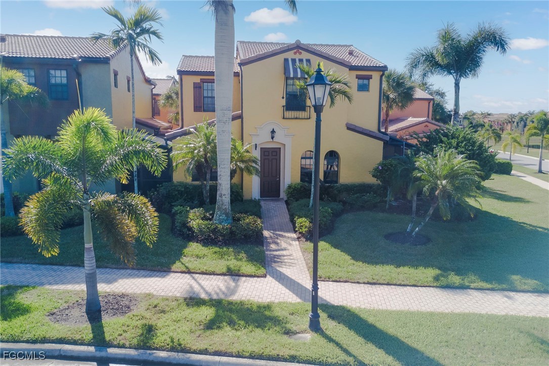 11856 Rocio Street, Unit 2003 Fort Myers, FL 33912 - Photo 2 of 43 a front view of a house with a yard