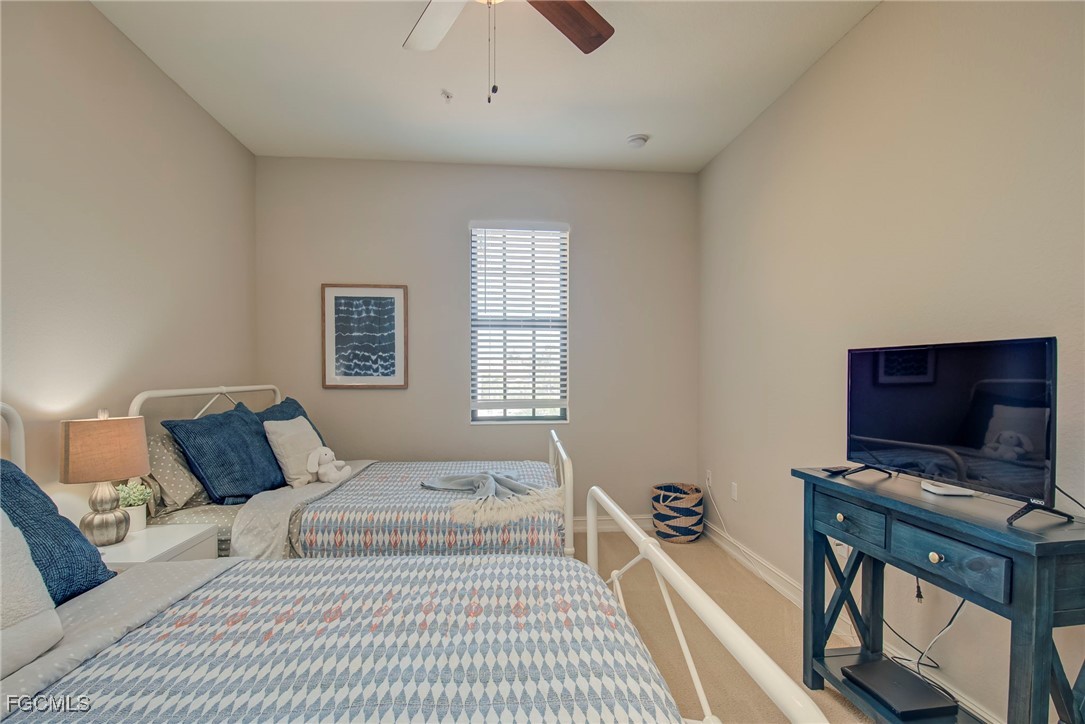 11856 Rocio Street, Unit 2003 Fort Myers, FL 33912 - Photo 24 of 43 a bedroom with a bed and a flat screen tv