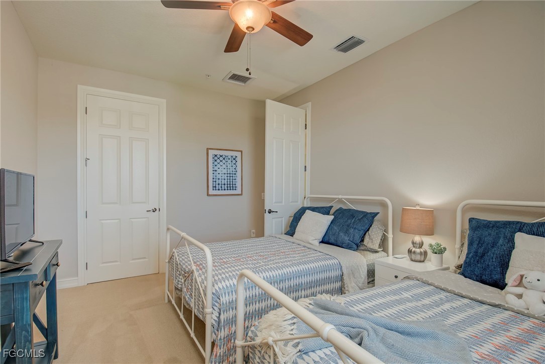 11856 Rocio Street, Unit 2003 Fort Myers, FL 33912 - Photo 25 of 43 a bedroom with a bed and a flat tv screen