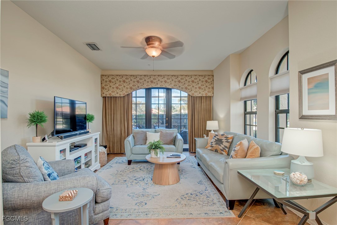 11856 Rocio Street, Unit 2003 Fort Myers, FL 33912 - Photo 3 of 43 a living room with furniture and a flat screen tv