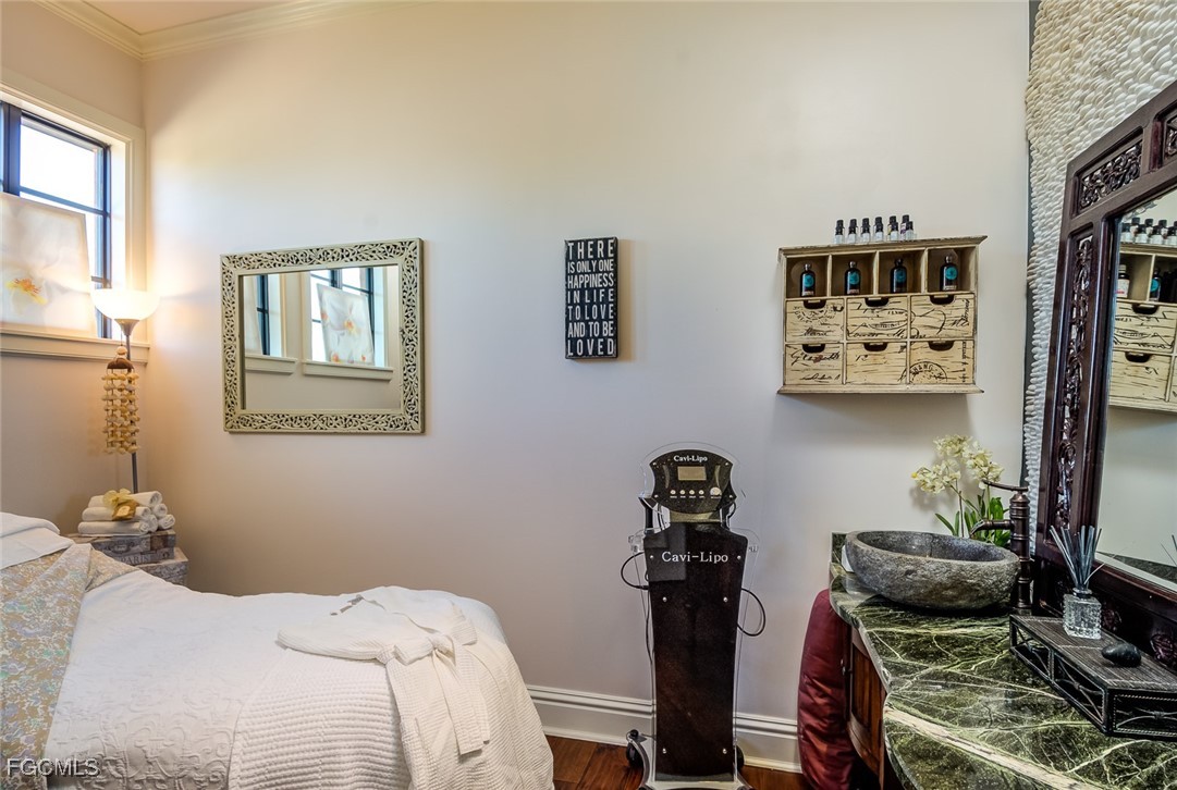 11856 Rocio Street, Unit 2003 Fort Myers, FL 33912 - Photo 41 of 43 a bedroom with a bed and wooden floor