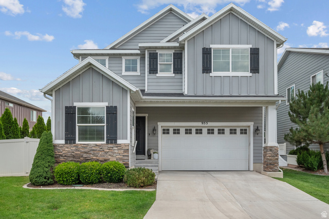 955 Delorean Lane Midvale, UT 84047 - Photo 2 of 47 Contemporary two-story residence featuring grey siding, stone accents, and dark shutters