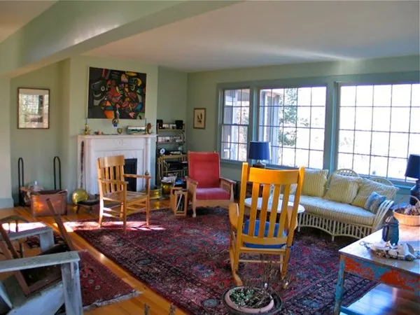 a living room with furniture fireplace and a large window