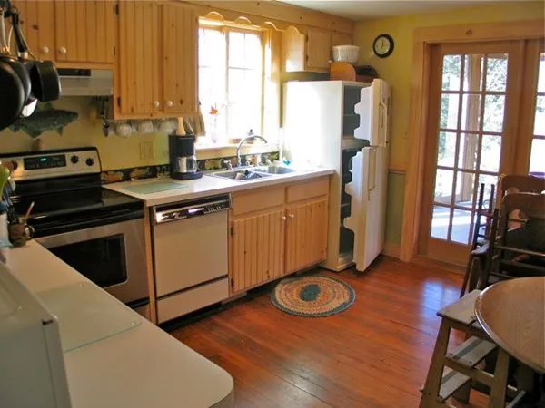 a kitchen with sink refrigerator and window