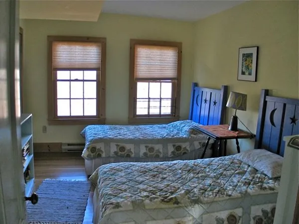 a bed sitting in a bedroom next to a window