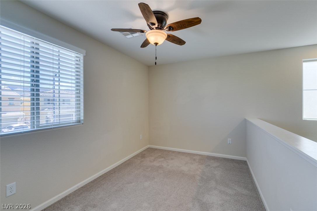 2549 Sable Ridge Street Henderson, NV 89044 - Photo 35 of 48 An airy loft with soft carpeting and ample natural light, creating a serene environment.