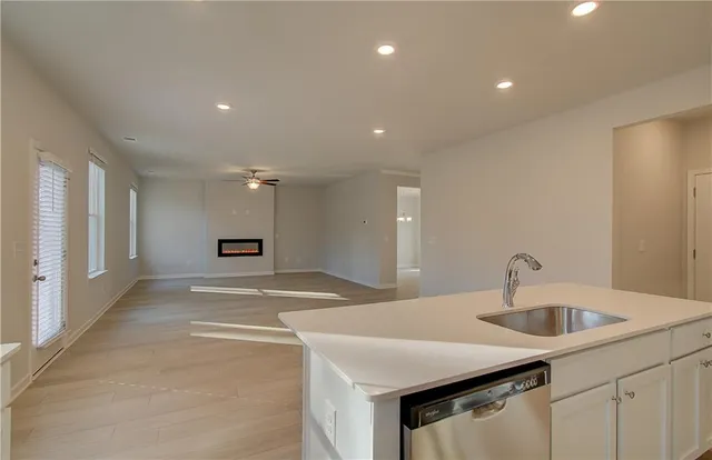 a kitchen with sink and mirror