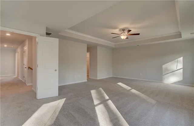 a view of an empty room with a ceiling fan