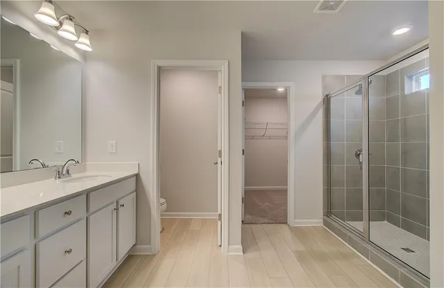a bathroom with a shower sink and mirror