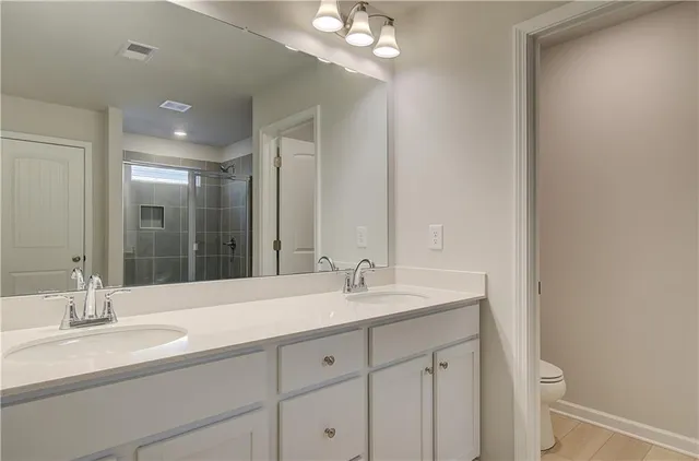 a bathroom with a double vanity sink and a mirror