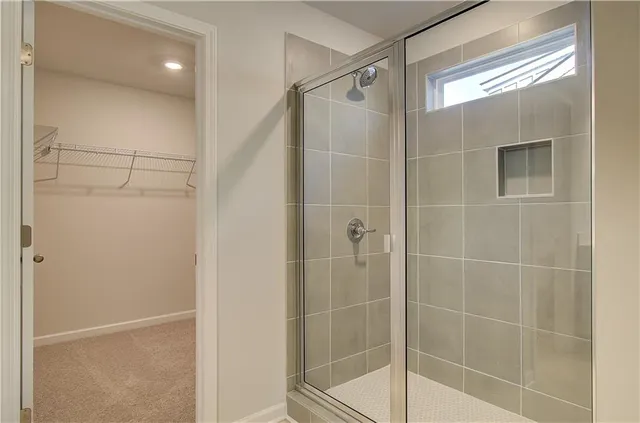 a bathroom with a shower and a glass door