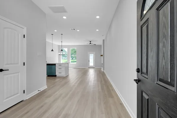 a view of a hallway with wooden floor