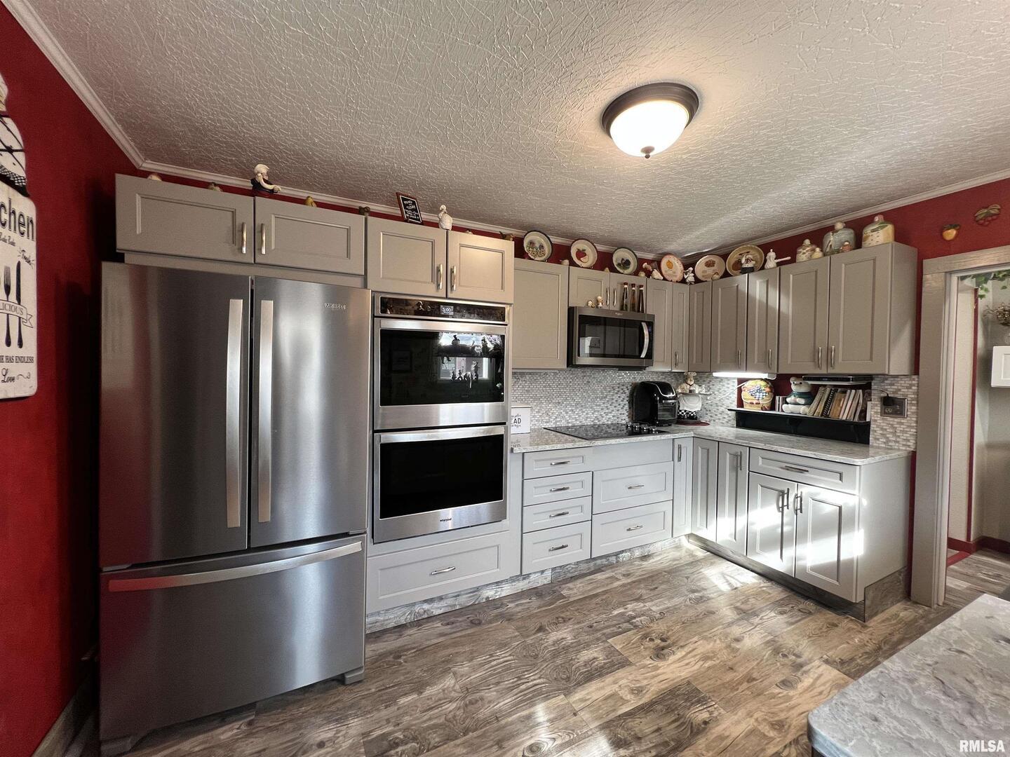 209 Northwest 6th Street Aledo, IL 61231 - Photo 5 of 28 a kitchen with granite countertop a refrigerator stove and microwave