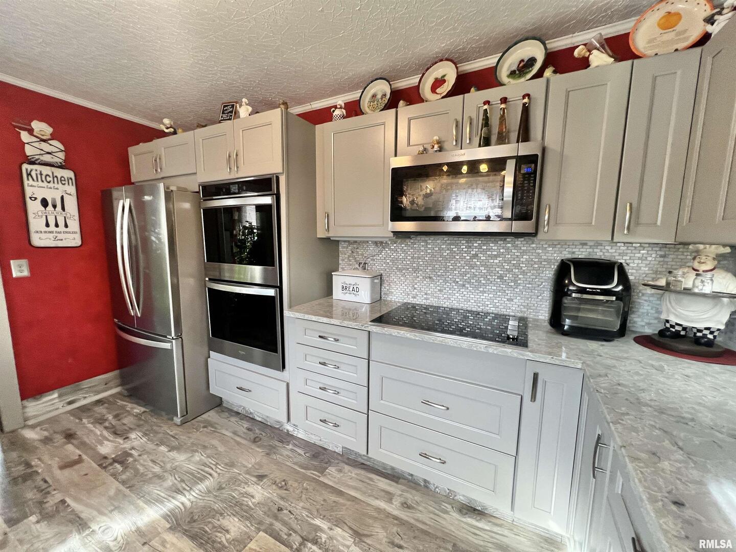 209 Northwest 6th Street Aledo, IL 61231 - Photo 9 of 28 a kitchen with stainless steel appliances a stove a refrigerator and cabinets